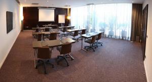 a conference room with tables and chairs and a projection screen at Hotel Vilamarí in Barcelona