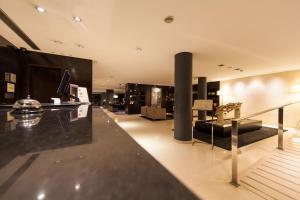 a large room with a lobby with a store at Hotel Vilamarí in Barcelona