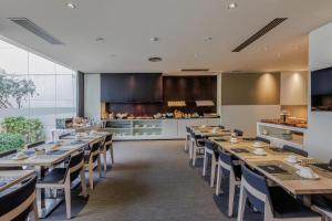 a dining room with wooden tables and chairs at Hotel Vilamarí in Barcelona