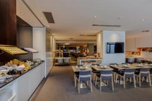 a restaurant with tables and chairs and a buffet at Hotel Vilamarí in Barcelona +36 photos