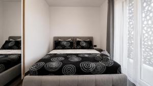 a bedroom with a bed with black and white pillows at Art Suite - Private Parking in Oradea