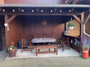 a patio with a table and chairs and a bench at Thea in Gatersleben