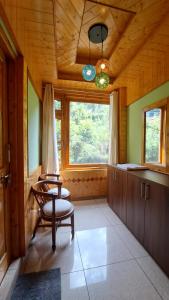 a living room with a chair and a window at Himalayan Hideaway Homestay in Kasol