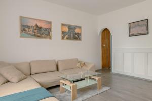 a living room with a couch and a table at Terminal Garden Apartman in Budapest