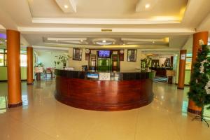 a large lobby with a bar in the middle at Asamar Country Resort in Mbarara
