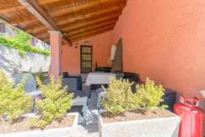 a patio with a table and chairs and a fire hydrant at Ina's Lake Garden, Como Lake in Lenno
