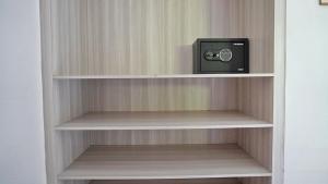 a book shelf with a small tv on it at Kubu Kiku Megati in Selemadeg