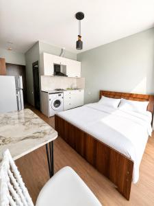 a bedroom with a large bed and a table at Complex DEL MAR in Chakvi