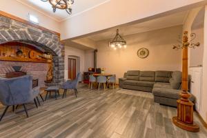 a living room with a couch and a fireplace at Ina's Lake Garden, Como Lake in Lenno