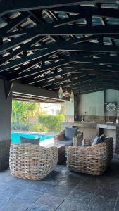 a patio with two wicker chairs and a table at Bee Boutique Lodge in Nelspruit