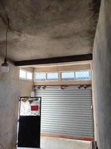 a garage with a garage door and a window at Skikda in Cité el ʼArbi Ben Mhîdi
