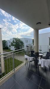a balcony with a table and chairs on a balcony at Tale Coast Apartments in Tale