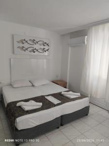 a bedroom with a bed with towels on it at Blue Garden Family Side in Side +10 photos