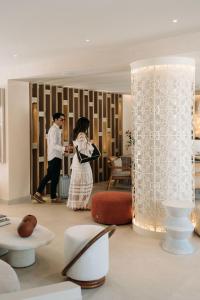 a man and a woman standing in a room at Santorini Heart Hotel & Spa in Fira +98 photos