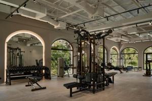 a gym with many exercise equipment in a room at OKU Andalusia in La Alcaidesa