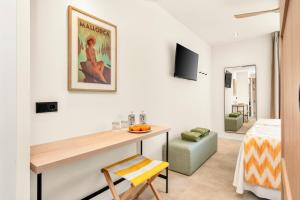 a living room with a desk and a bedroom at Tangerine by Honne Hotels - Adults Only in Magaluf