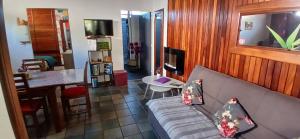 a living room with a couch and a dining room at Le Papyrus in Cilaos