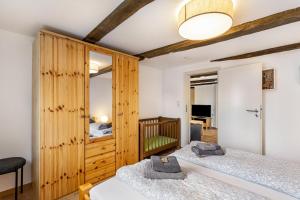 a bedroom with two beds and a crib at Ferienhof Riekeshof in Schmallenberg +209 photos