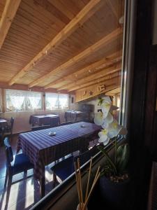 a dining room with a table and chairs in a room at Кацарила in Gabrovo