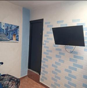 a wall with a tv attached to a brick wall at Bleu Chefchaouen in Chefchaouen