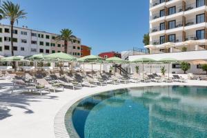 a swimming pool with lounge chairs and umbrellas at a hotel at Tangerine by Honne Hotels - Adults Only in Magaluf