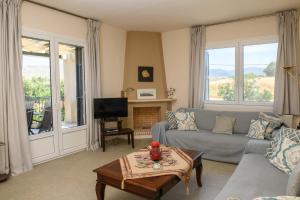 a living room with a couch and a tv at Anasa Villas in Mythimna