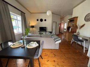 a living room with a table and a couch at Swellengrebel Nest in Swellendam