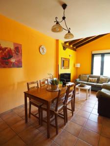 a living room with a table and a couch at La Senda Del Duratón in Sebúlcor
