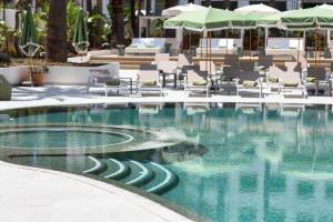 a swimming pool with chairs and umbrellas at a hotel at Tangerine by Honne Hotels - Adults Only in Magaluf