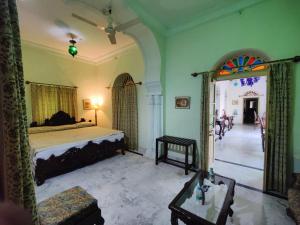 a bedroom with a bed and a large mirror at Palkiya Haveli - Heritage Hotel in Kota