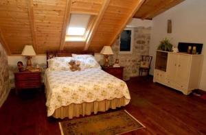 a bedroom with a bed with a teddy bear on it at The Villa Vatikan in Trpanj