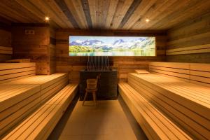 a sauna with a large tv on the wall at LUMA Stubai Aparthotel - Neueröffnung inklusive STUBAI SUPER CARD in Neustift im Stubaital