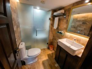 a bathroom with a toilet and a sink at Elite Hotel Airport in Dhaka +25 photos