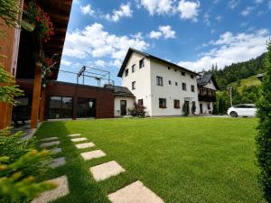 a house with a green lawn in front of it at Casa Ambra in Sadova