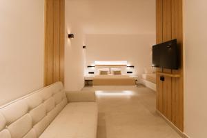a bedroom with a bed and a flat screen tv at Ios Sea view apartment with pool 2B in Ios Chora