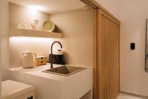 a bathroom with a sink and a toilet at Ios Sea view apartment with pool 2B in Ios Chora
