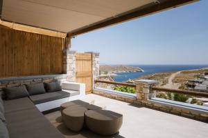 a patio with a couch and a view of the ocean at Ios Sea view apartment with pool 2B in Ios Chora