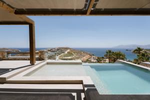 a swimming pool with a view of the ocean at Ios Sea view apartment with pool 2B in Ios Chora