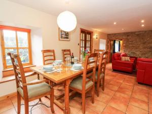 a dining room with a wooden table and chairs at Elm Cottage in Aberfeldy +13 photos