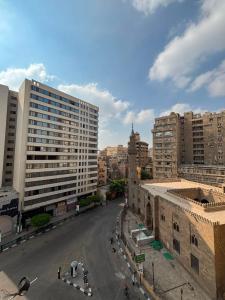 an empty street in a city with tall buildings at Via Cairo hotel in Cairo