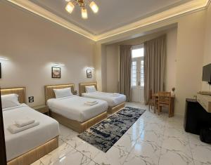 a hotel room with two beds and a television at Via Cairo hotel in Cairo +39 photos