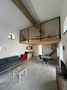 a living room with a couch and a table at Apartma OLJKA in Črniče
