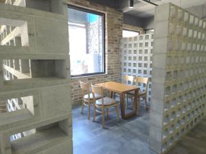 a dining room with a table and chairs and a window at AREA HoTEL in Yeongju