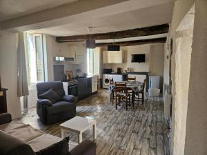 a living room with a couch and a table at Le papey in Molières-Cavaillac