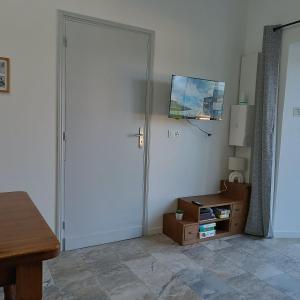 a room with a door and a table and a desk at Pyrenees Vue Gite - Owl - Vues Fantastique, Petit-Déjeuner, Calme, Piscine, Parking - Brand New in Saint-Gaudens