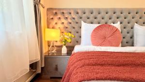 a bedroom with a large bed with a red pillow at Stavilar Hotel - Charming Stay Just Steps Away from Peles Castle in Sinaia in Sinaia