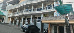 a black car parked in front of a building at Griya Imafa Inn Batu in Tlekung