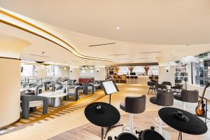 a restaurant with chairs and tables in a room at Fox Hotel Nagoya Batam in Nagoya +23 photos