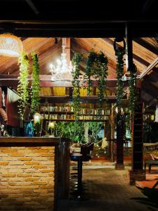 a bar with plants on the wall and a chandelier at Nong Thale Garden in Ban Khao Klom
