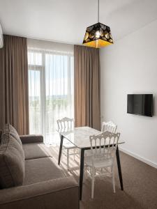 a living room with a table and a couch at Complex DEL MAR in Chakvi